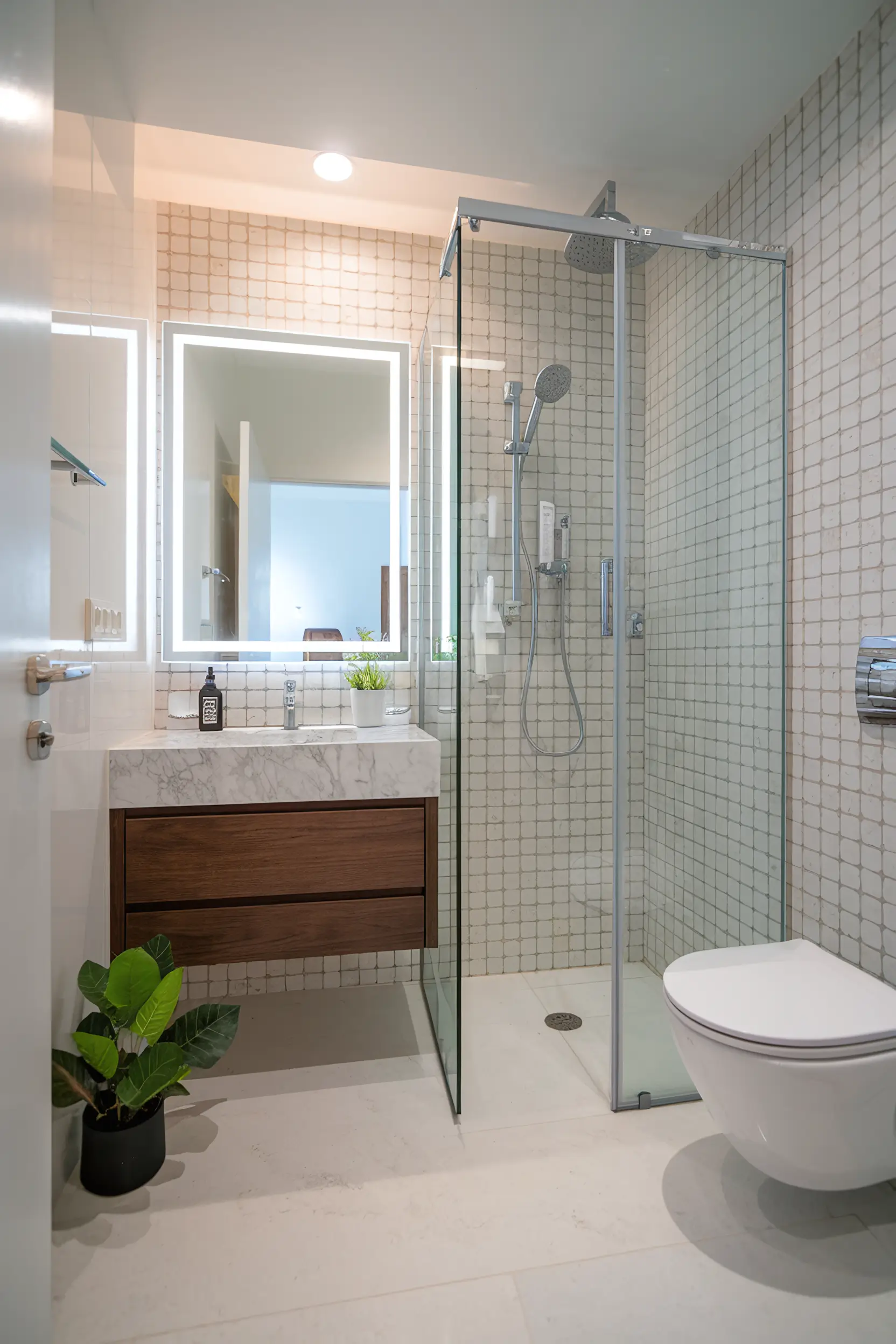 Compact and luxurious apartment bathroom with high-end materials and space-saving solutions.