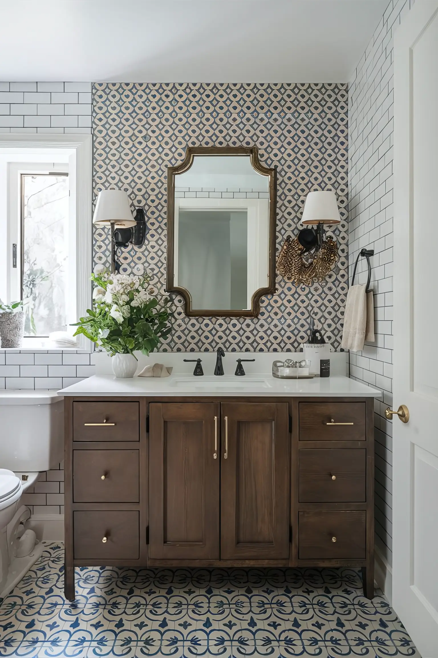 Bathroom remodel with classic subway tiles and intricate mosaic patterns.