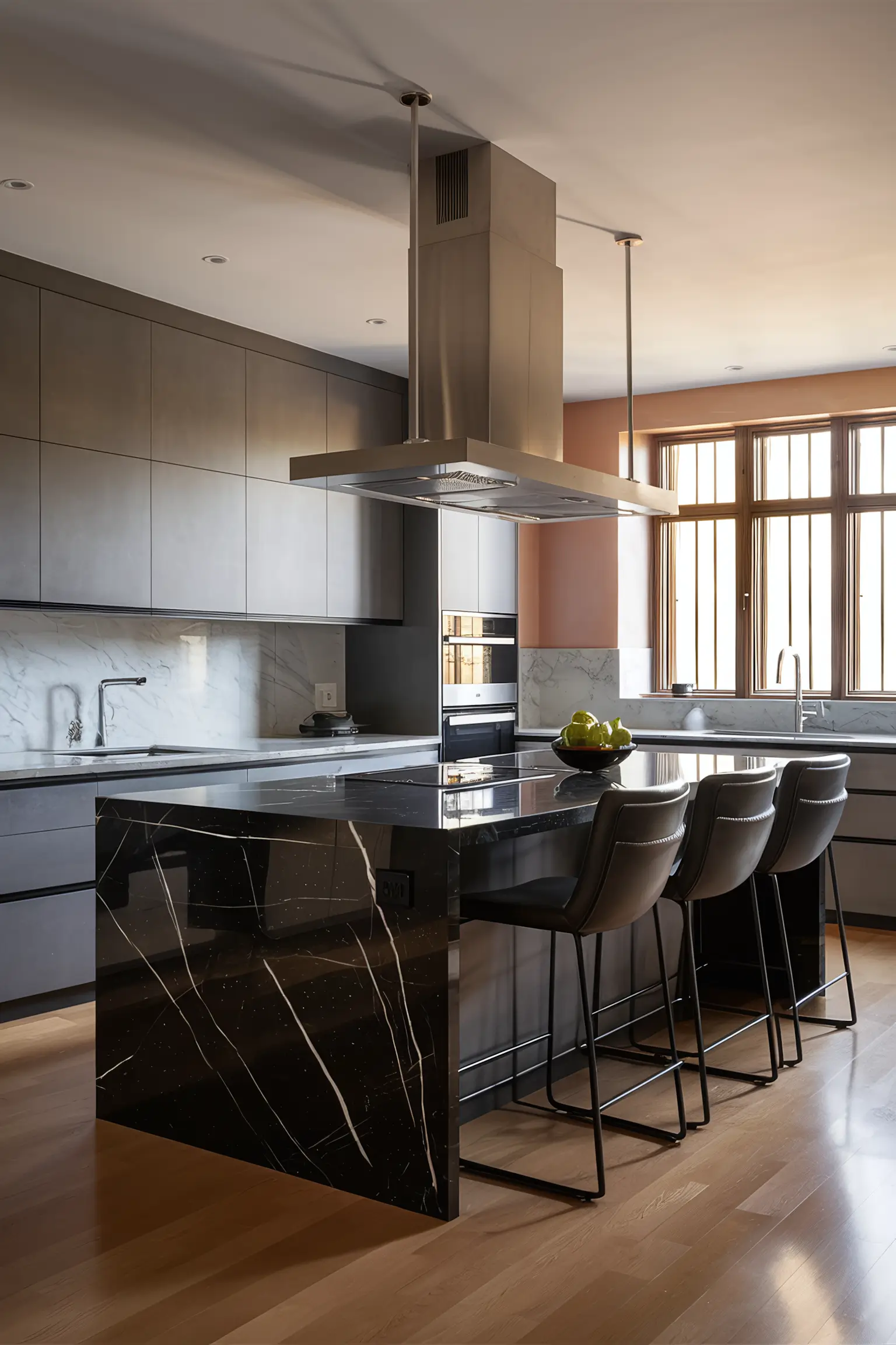 Black kitchen island paired with sleek grey cabinets in a contemporary kitchen.