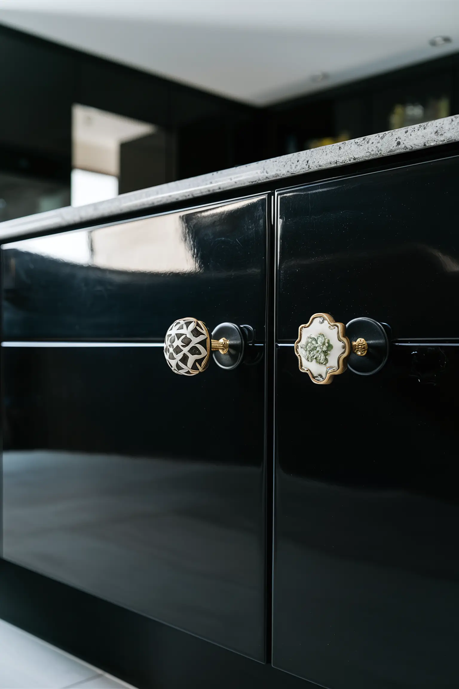 Black kitchen island with stylish and unique knobs in various designs.