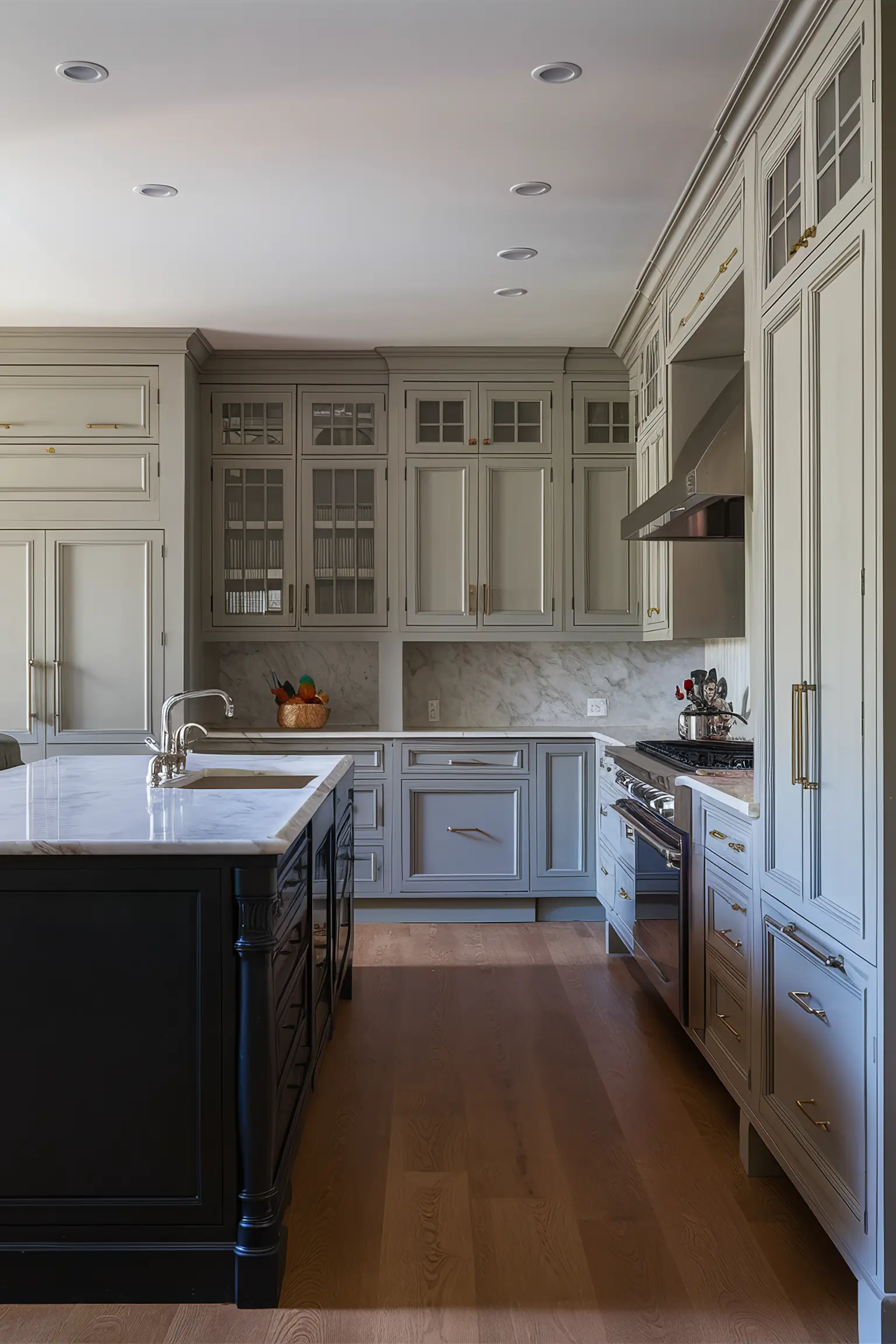 Black kitchen island with complementary paint colors in a stylish kitchen.